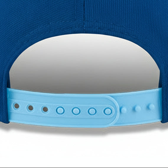 Close-up of a blue cap with a light blue strap on a white background