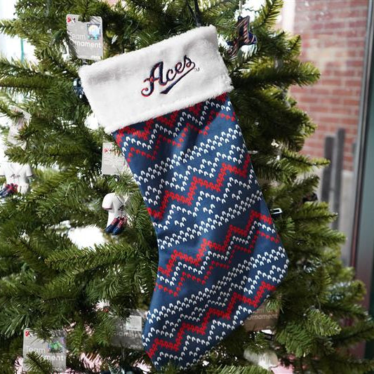 Christmas stocking with zigzag pattern and 'Aces' text on a decorated tree.
