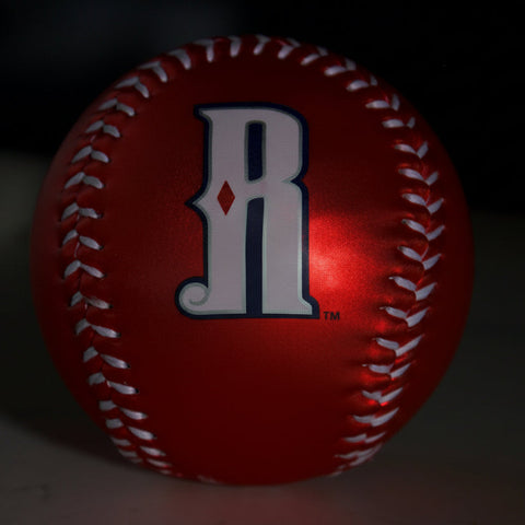 Red baseball with a logo on a dark background